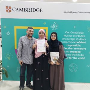 Sameera is depicted with a brilliant smile together with her parents while holding her certificate